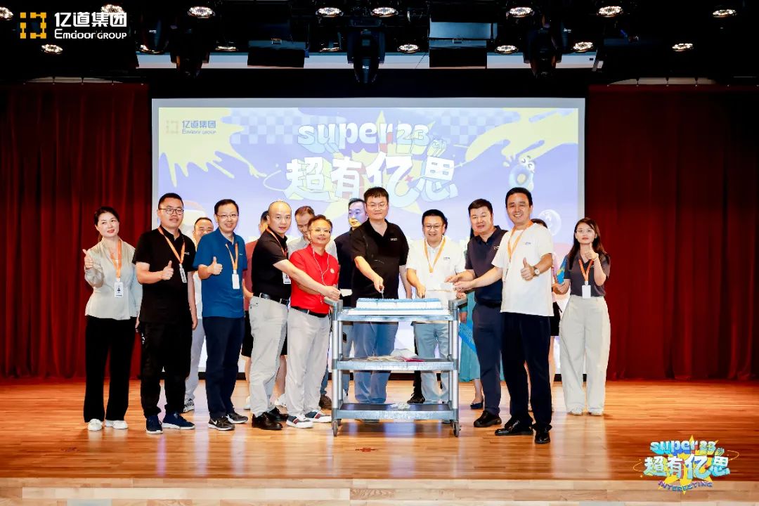 Emdoor Group leaders cutting cake at 23rd anniversary