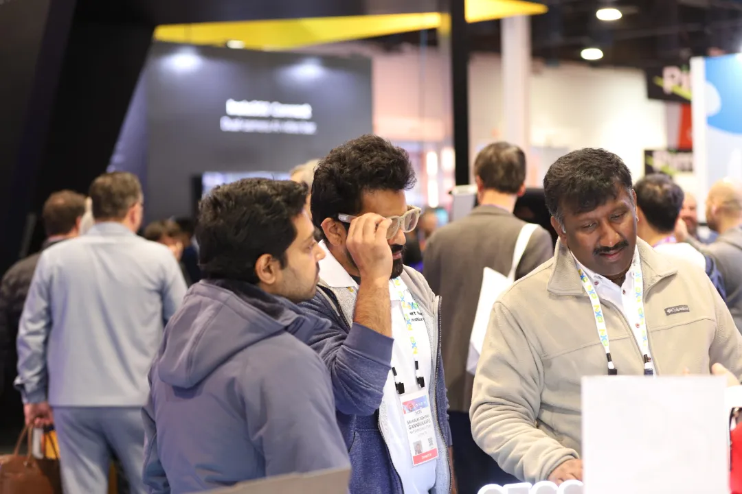 Visitors trying Emdoor AI glasses at CES 2025 booth